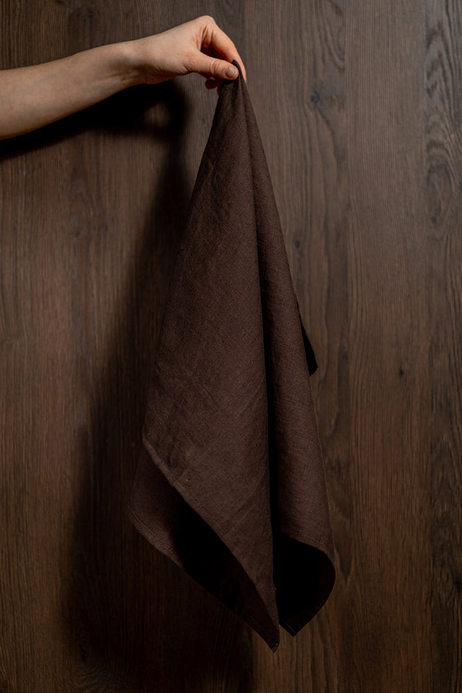 brown linen tea towel holding with hand