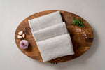 natural durable linen tea towels on the oak wood cutting board
