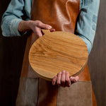 oak wood serving board holding in hands