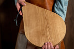 chef holding in hands serving and cutting board in solid oak wood 